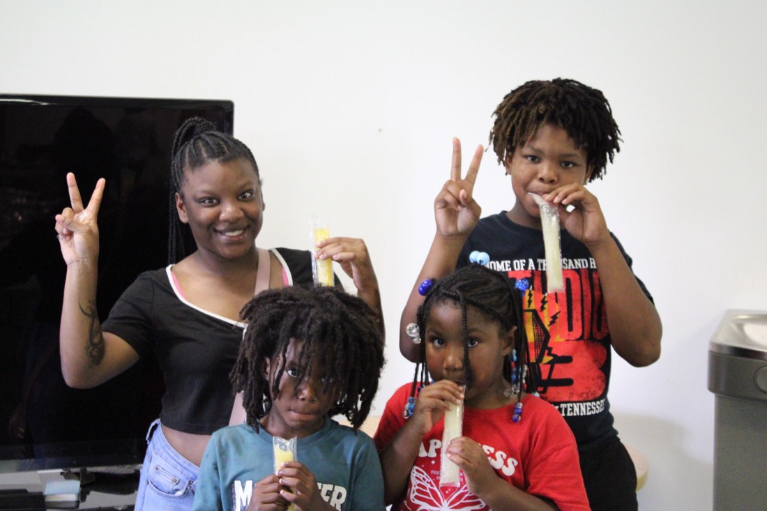 Children enjoying frozen treats and posing at Community Day