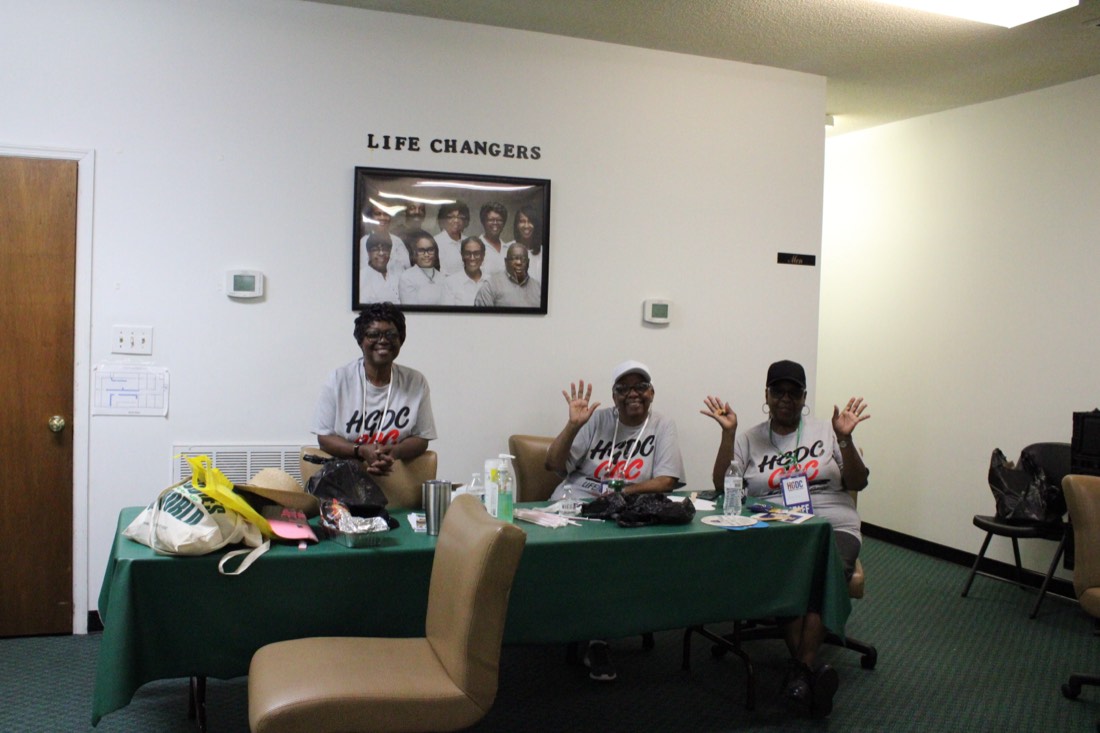 HGDC volunteers waving from the welcome table
